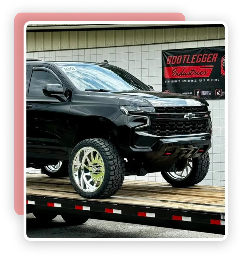 a black truck on a flatbed