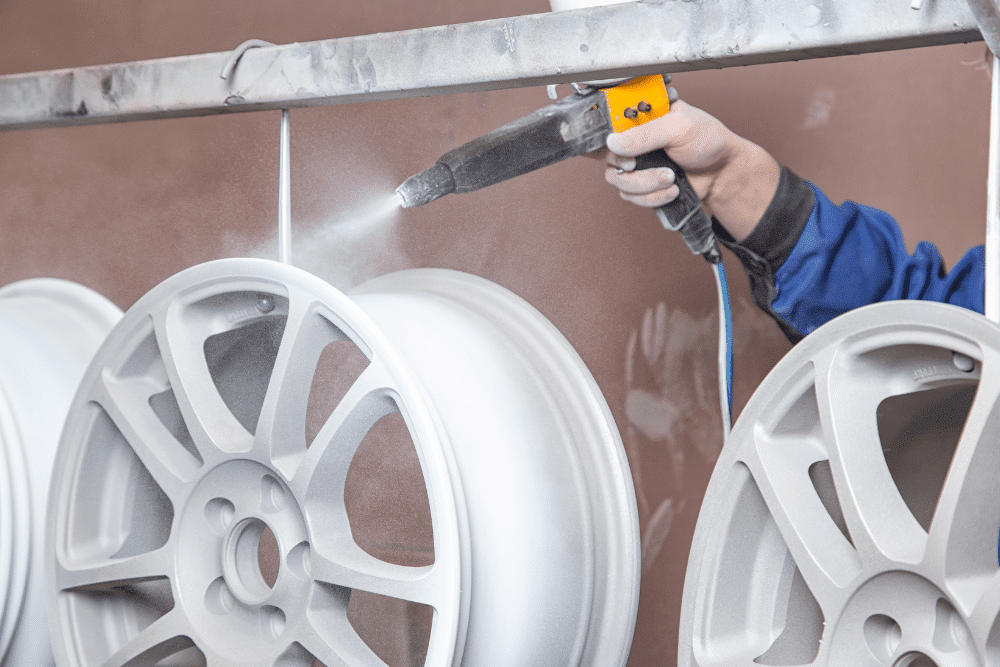 Powder coating in Oak Ridge, TN by Moonshine Diesel. Image of alloy wheels being powder coated, showcasing precision refinishing for durability, safety, and enhanced vehicle performance.